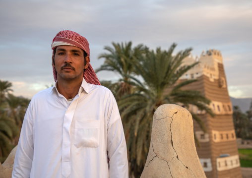 Saudi man on the terrace of his traditional mud houses, Najran Province, Najran, Saudi Arabia