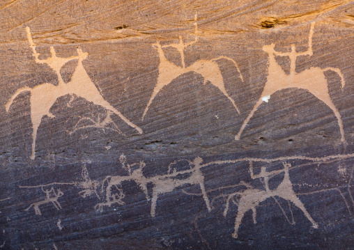 Petroglyphs on a rock depicting hunters riding horses, Najran Province, Thar, Saudi Arabia