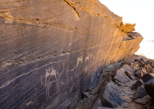 Petroglyphs on a rock depicting hunters riding horses, Najran Province, Thar, Saudi Arabia