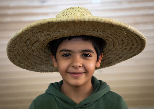Saudi boy wearing a large hat, Najran Province, Najran, Saudi Arabia