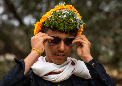 Portrait of a flower man wearing a floral crown on the head, Asir province, Sarat Abidah, Saudi Arabia
