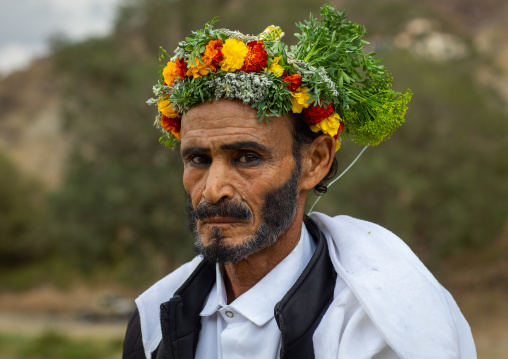 Portrait of a flower man with a floral crown on the head and kohl on his eyes, Asir province, Sarat Abidah, Saudi Arabia
