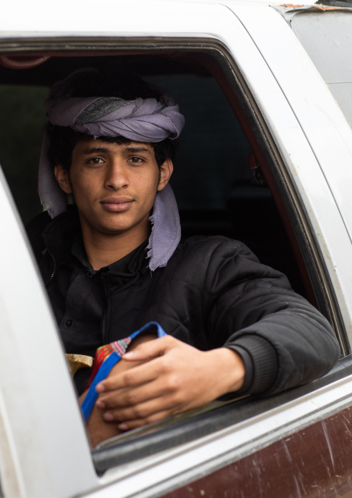 Portrait of a young man driving a car, Asir province, Sarat Abidah, Saudi Arabia