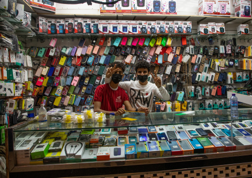 Sellers in a mobile phone shop, Jizan Province, Jizan, Saudi Arabia