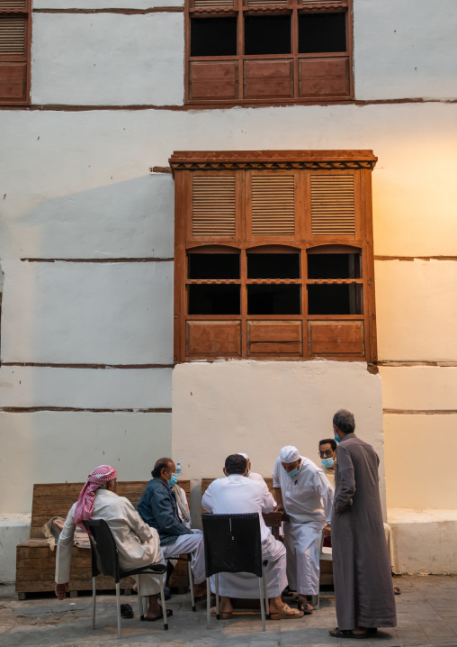 Men playing chess in front of an old house in al-Balad quarter, Mecca province, Jeddah, Saudi Arabia