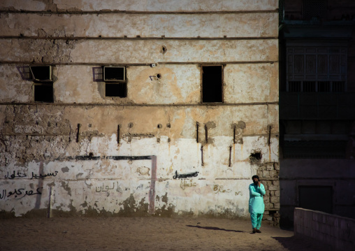 Man on the phone in front of old house in al-Balad quarter, Mecca province, Jeddah, Saudi Arabia