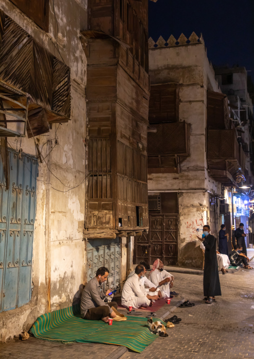 Men having lunch in the streets of al-Balad quarter, Mecca province, Jeddah, Saudi Arabia