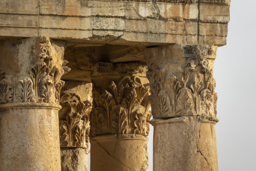 Several Corinthian columns with carved acanthus capitals stand side by side at the ancient Roman temple ruins, Baalbek-Hermel Governorate, Baalbek, Lebanon