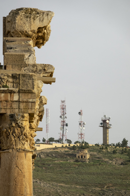 Ancient Roman columns tower over a hillside dotted with modern telecommunication towers in the distance, Baalbek-Hermel Governorate, Baalbek, Lebanon