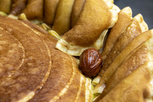 A folded pastry reveals a soft date filling nestled among golden baked dough, South Governorate, Tyre, Lebanon