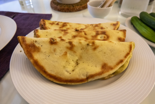 Folded manoushe flatbreads are stacked on a plate ready to be served for breakfast, Beirut Governorate, Beirut, Lebanon