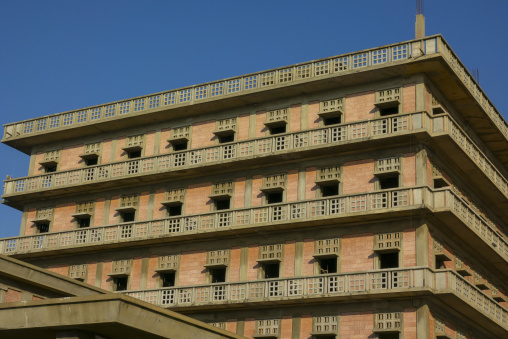 Rows of empty balconies line the corner of the abandoned war-damaged Saint George Hotel under a clear blue sky, Beirut Governorate, Beirut, Lebanon