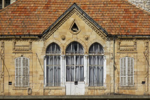 A traditional Lebanese stone house features a triple-arched window beneath a red tile roof, Beqaa Governorate, Zahle, Lebanon