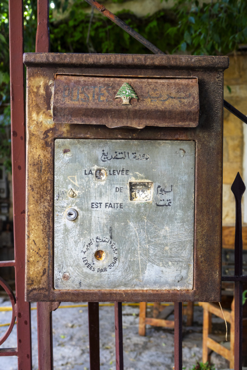 An antique rusted mailbox bears the cedar tree emblem of the Lebanese postal service, North Governorate, Tripoli, Lebanon