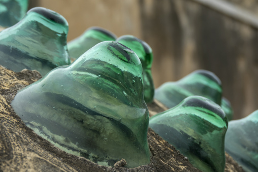 Rows of traditional green glass roof tiles from the historic Ezzeddine Hammam catch the light in close-up detail, North Governorate, Tripoli, Lebanon