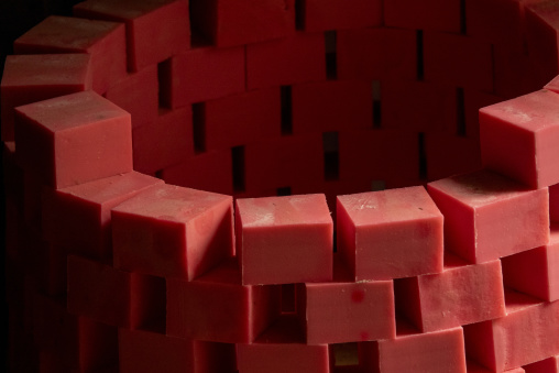 Rows of handmade red soap bars dry in wooden molds at a traditional workshop, North Governorate, Tripoli, Lebanon