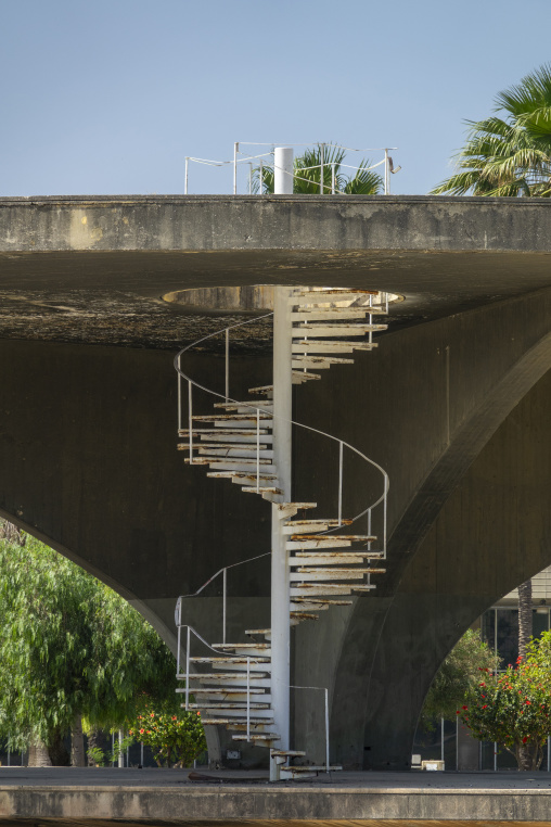A white spiral staircase descends from an elevated modernist concrete structure at the Rashid Karami International Fair designed by architect Oscar Niemeyer, North Governorate, Tripoli, Leban