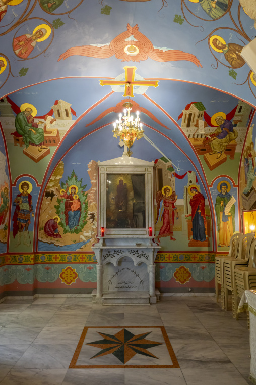 Painted frescoes of saints and a marble altar decorate the interior of a small chapel at Our Lady of Nourieh Orthodox Monastery, North Governorate, Hamat, Lebanon