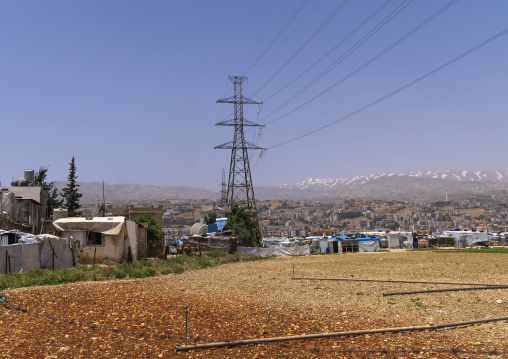 Surian refugees camp under a electric pylon, Beqaa Governorate, Rayak, Lebanon
