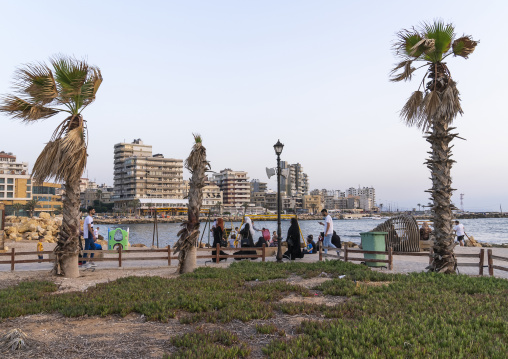 Families in a playground on the seafront, North Governorate, Tripoli, Lebanon