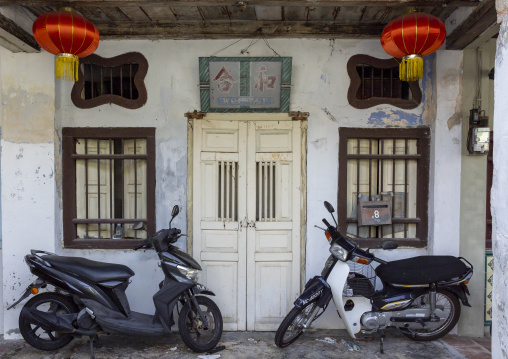 Scooters parked in front of a n old house in the Unesco World Heritage area, Penang island, George Town, Malaysia