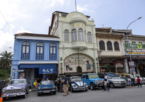 Old cars parked in front of heritage shophouses, Perak, Ipoh, Malaysia