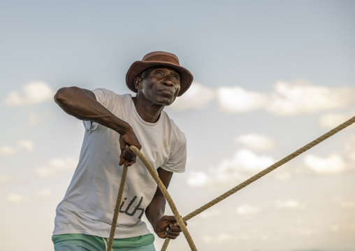 Man pulling ropes on a dhow, Nampula Province, Island of Mozambique, Mozambique