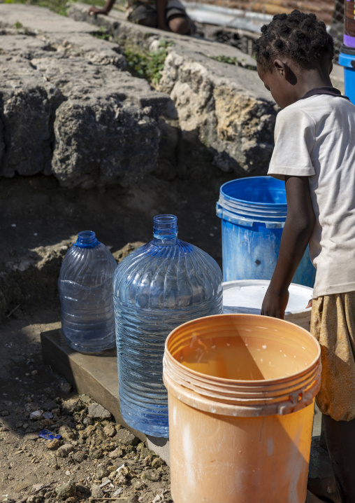 Girl collecting drinking water in a paid pump, Nampula Province, Island of Mozambique, Mozambique