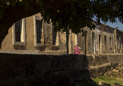Muslim girl walking along old portuguese houses, Nampula Province, Island of Mozambique, Mozambique