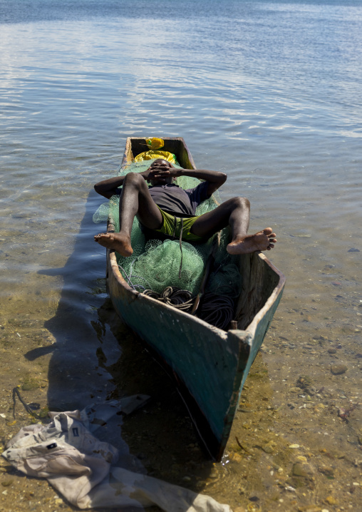 Fisherman relaxing on his small boat, Nampula Province, Island of Mozambique, Mozambique