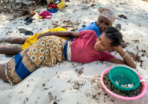 Young women resting on the beach, Inhambane Province, Inhambane, Mozambique