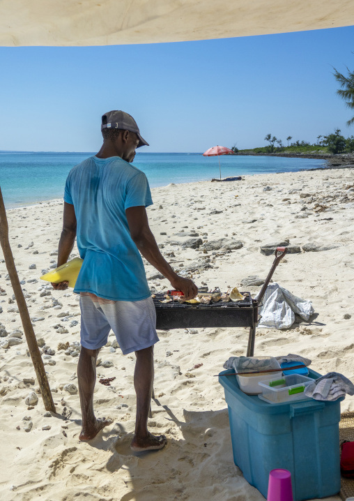 Man cooking seafood on a barbecue, Nampula Province, Island of Mozambique, Mozambique