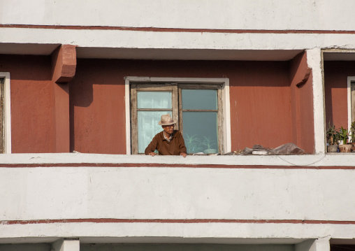 North Korean man on his balcony, DGC, Pyongyang, North Korea