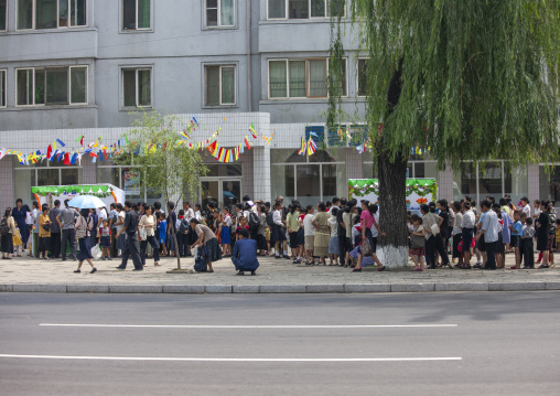 North Korean people queuing to buy some food in a small shop, DGC, Pyongyang, North Korea