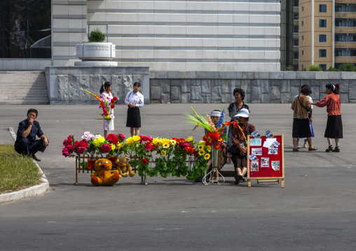 North Korean women selling flowers in the street, DGC, Pyongyang, North Korea