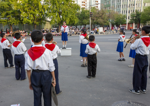 Pioneers playing music in the street during a celebration, DGC, Pyongyang, North Korea