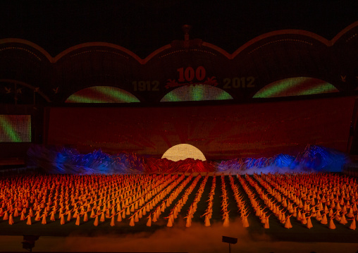 Dancers in front of rising sun over mount Paektu boards during Arirang, DGC, Pyongyang, North Korea