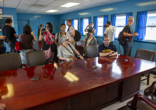 Tourists in the conference room of the United Nations in the DMZ, North Hwanghae, Panmunjom, North Korea