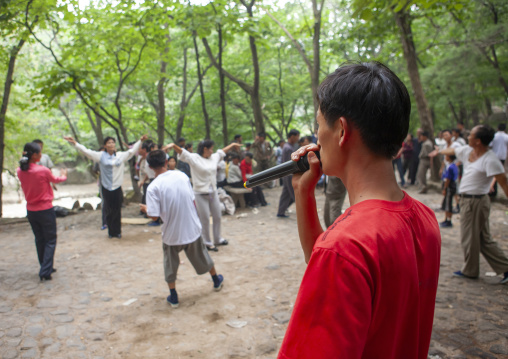 North Korean electricity company workers singing in a park, North Hwanghae, Kaesong, North Korea