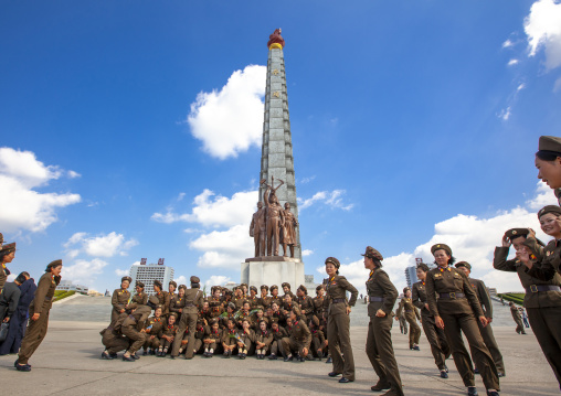 North Korean female soldiers posing in front of the Juche tower, DGC, Pyongyang, North Korea