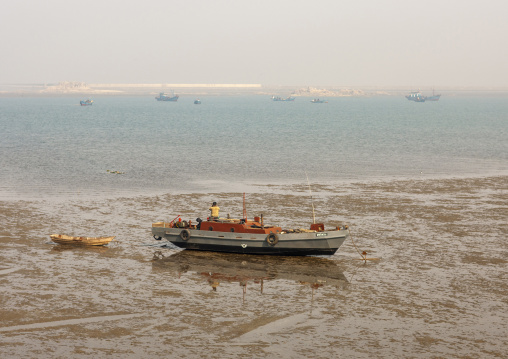 North Korean fishermen boat at low tide, South Pyongan, Nampo, North Korea