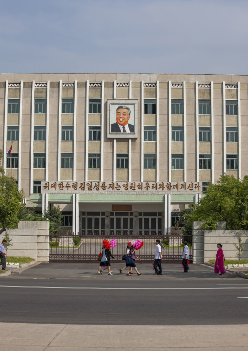 People going to the celebration of the regim with plastic bunches of flowers, DGC, Pyongyang, North Korea