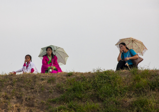 North Korean women with umbrellas, DGC, Pyongyang, North Korea