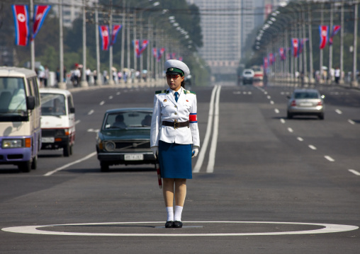 North Korean female traffic security officer in white uniform in the street, DGC, Pyongyang, North Korea