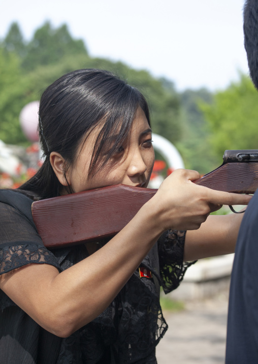 North Korean woman shooting on a target in fun fair, DGC, Pyongyang, North Korea