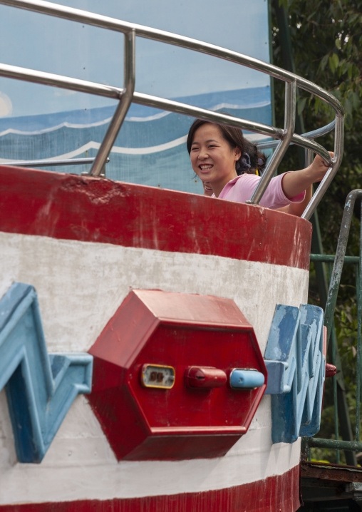 North Korean woman enjoying an attraction in Taesongsan funfair, DGC, Pyongyang, North Korea
