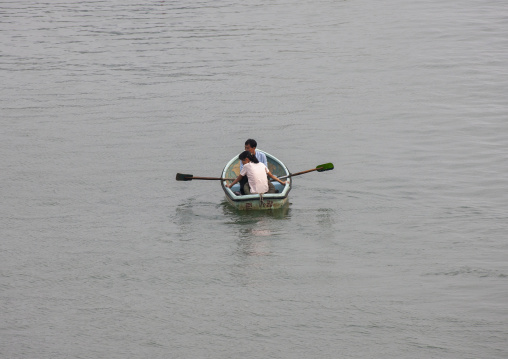 North Korean people in rowing boats on Taedong river, DGC, Pyongyang, North Korea