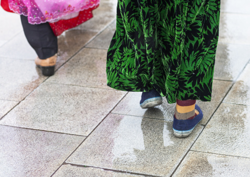 North Korean women under the rain in Kumsusan memorial palace, DGC, Pyongyang, North Korea