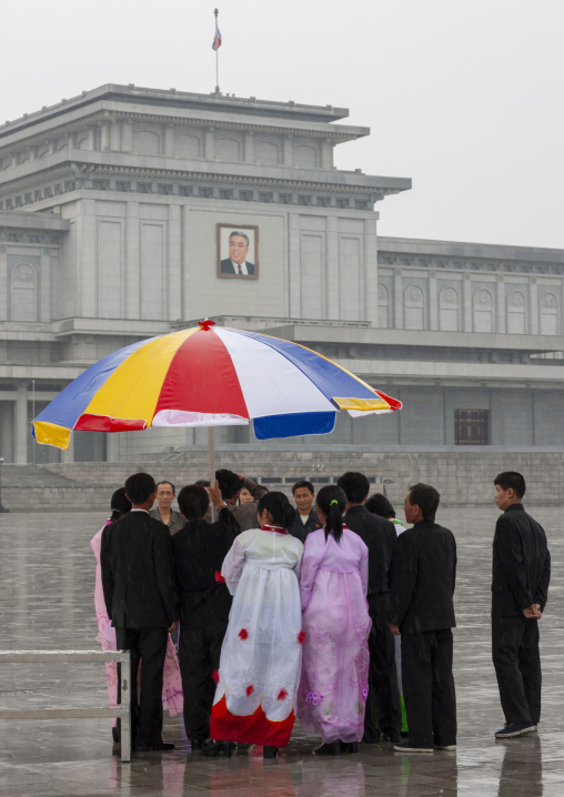 North Korean people under the rain in Kumsusan memorial palace, DGC, Pyongyang, North Korea