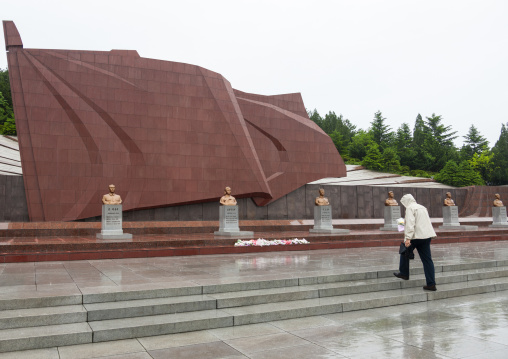 Western tourist bringing flowers to Taesongsan revolutionary martyr's cemetery, DGC, Pyongyang, North Korea